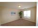 Spacious bedroom with carpeting, large window, and coastal art at 11370 Clubhaven Pl # 103, Raleigh, NC 27617
