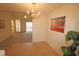 Bright dining area with tile floors, chandelier, and views to living room at 11370 Clubhaven Pl # 103, Raleigh, NC 27617