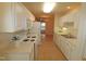 Open kitchen with white cabinets, and view to living area at 11370 Clubhaven Pl # 103, Raleigh, NC 27617