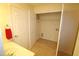 Bright laundry room with built-in shelving and tile floor at 11370 Clubhaven Pl # 103, Raleigh, NC 27617