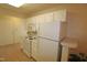 Clean kitchen offering white cabinetry, stove, microwave and refrigerator at 11370 Clubhaven Pl # 103, Raleigh, NC 27617