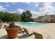 Relaxing community pool with plenty of lounge chairs for residents at 11370 Clubhaven Pl # 103, Raleigh, NC 27617