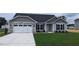 Exterior view of a charming ranch home with a two-car garage and stone accents at 215 Merrifield Ln, Garner, NC 27529