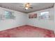 Bedroom with pink carpet, ceiling fan, and window shutters at 2509 Mckinney St, Burlington, NC 27217