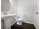 Clean bathroom with pedestal sink and dark hardwood floor at 1466 Salem Creek Dr, Apex, NC 27502