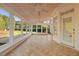 Bright sunroom with tile floors and ceiling fan, offering ample natural light and backyard access at 415 Wayfield Ln, Cary, NC 27518