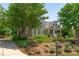 House exterior with a charming front porch and manicured landscaping at 6720 Fawn Hoof Trl, Holly Springs, NC 27540