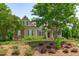 Exterior view of a two-story home with stone accents and a well-maintained lawn at 6720 Fawn Hoof Trl, Holly Springs, NC 27540
