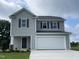 Two-story gray house with white garage door and landscaping at 44 Oakfield Trace Dr, Four Oaks, NC 27524