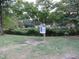 Community mailbox post in a grassy area with trees at 130 S Estes Dr # B-11, Chapel Hill, NC 27514