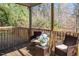 Relaxing screened porch with wooded views and wicker furniture at 671 Legend Oaks Dr, Chapel Hill, NC 27517