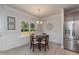 Bright breakfast nook with a table and four chairs, overlooking wooded area at 55 Streamline Ct, Lillington, NC 27546