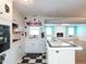 Kitchen with white cabinets, tile countertops, and a breakfast bar at 110 W Parker St, Smithfield, NC 27577