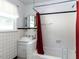 Clean bathroom with white tile and a bathtub at 110 W Parker St, Smithfield, NC 27577