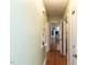 Hallway with light walls, wood floors and view to kitchen at 110 W Parker St, Smithfield, NC 27577