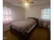 Bright bedroom with double bed, two chairs, and ample window light at 108 Gulf Dr, Dunn, NC 28334