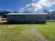 Rear view of house with large yard and AC unit at 108 Gulf Dr, Dunn, NC 28334