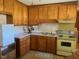 Retro kitchen with wood cabinets and yellow appliances at 108 Gulf Dr, Dunn, NC 28334