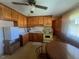 Retro kitchen with wood cabinets and yellow appliances at 108 Gulf Dr, Dunn, NC 28334