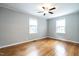 Well-lit bedroom featuring hardwood floors and ceiling fan at 116 Plainview Ave, Raleigh, NC 27604