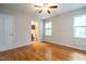 Spacious bedroom with hardwood floors, ceiling fan, and access to bathroom at 116 Plainview Ave, Raleigh, NC 27604