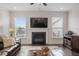 Bright living room featuring a fireplace and large windows at 421 Granite Saddle Dr, Rolesville, NC 27571