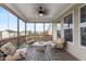 Relaxing screened porch with comfy seating and ceiling fan at 421 Granite Saddle Dr, Rolesville, NC 27571