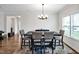 Bright dining area with a chandelier and seating for six at 254 Arlie Ln, Lillington, NC 27546