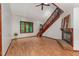 Living room with hardwood floors, fireplace, and staircase at 109 Essex Dr, Chapel Hill, NC 27514