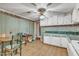Kitchen with green striped wallpaper and dining area at 9336 Baileywick Rd, Raleigh, NC 27615