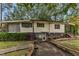 House exterior with walkway and mature trees at 9336 Baileywick Rd, Raleigh, NC 27615