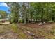 Wooded backyard with stone borders and garden areas at 9336 Baileywick Rd, Raleigh, NC 27615