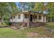 Ranch home with light yellow siding, brown trim, and covered porch at 9336 Baileywick Rd, Raleigh, NC 27615