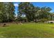 Spacious backyard with green grass and trees at 9336 Baileywick Rd, Raleigh, NC 27615