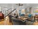 Open living room with hardwood floors, staircase, and seating area at 1021 Dimmocks Mill Rd, Hillsborough, NC 27278