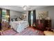 Cozy bedroom with antique bed frame and hardwood floors at 1021 Dimmocks Mill Rd, Hillsborough, NC 27278