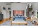 Spacious main bedroom with a sitting area, spiral staircase, and hardwood floors at 1021 Dimmocks Mill Rd, Hillsborough, NC 27278