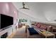 Media room with large TV, sectional sofa, and hardwood floors at 1021 Dimmocks Mill Rd, Hillsborough, NC 27278