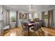 Bright dining room with hardwood floors and chandelier at 1021 Dimmocks Mill Rd, Hillsborough, NC 27278