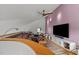 Media room with large TV, sectional sofa, and hardwood floors at 1021 Dimmocks Mill Rd, Hillsborough, NC 27278