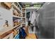 Well-organized pantry with ample shelving and large refrigerator at 1021 Dimmocks Mill Rd, Hillsborough, NC 27278