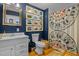Bathroom with white vanity, blue walls, and patterned shower curtain at 1021 Dimmocks Mill Rd, Hillsborough, NC 27278