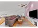 Media room with large TV, sectional sofa, and hardwood floors at 1021 Dimmocks Mill Rd, Hillsborough, NC 27278