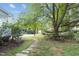Landscaped backyard with hammock and stone pathway at 1021 Dimmocks Mill Rd, Hillsborough, NC 27278