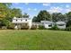 Two-house property with large yard, showcasing a white farmhouse and modern addition at 1021 Dimmocks Mill Rd, Hillsborough, NC 27278