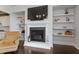 Fireplace with a white mantel and built-in shelves at 116 Mystic Quartz Ln, Holly Springs, NC 27540