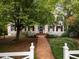 Attractive front yard with a brick pathway leading to the house entrance at 1208 College Pl, Raleigh, NC 27605