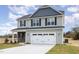 Two-story house with gray siding, stone accents, and a white garage door at 275 Trescott St, Smithfield, NC 27577