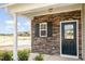 Dark green front door with stone surround and white framed window at 275 Trescott St, Smithfield, NC 27577