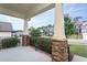 Covered front porch with stone pillars and view of neighborhood at 453 Granite Saddle Dr, Rolesville, NC 27571